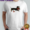 Top Dachshund running with a bouquet of red flowers in her mouth shirt